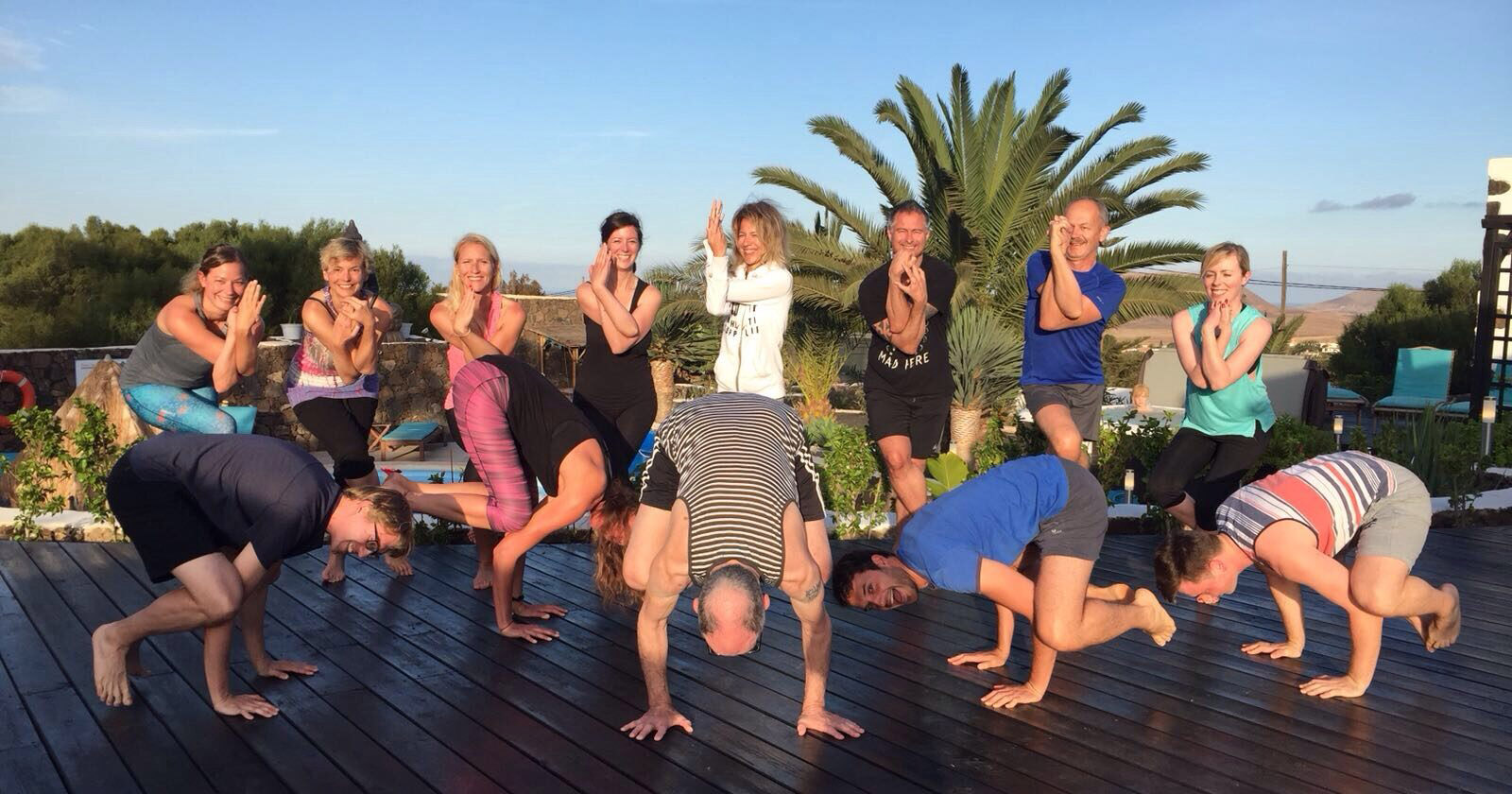 Smiling group class on the yoga deck at Surya Retreat
